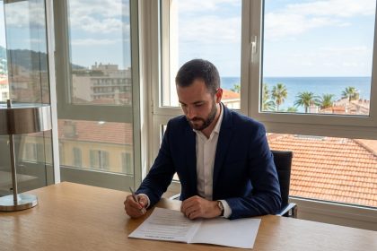 Homme d'affaires en costume à Nice regardant un contrat